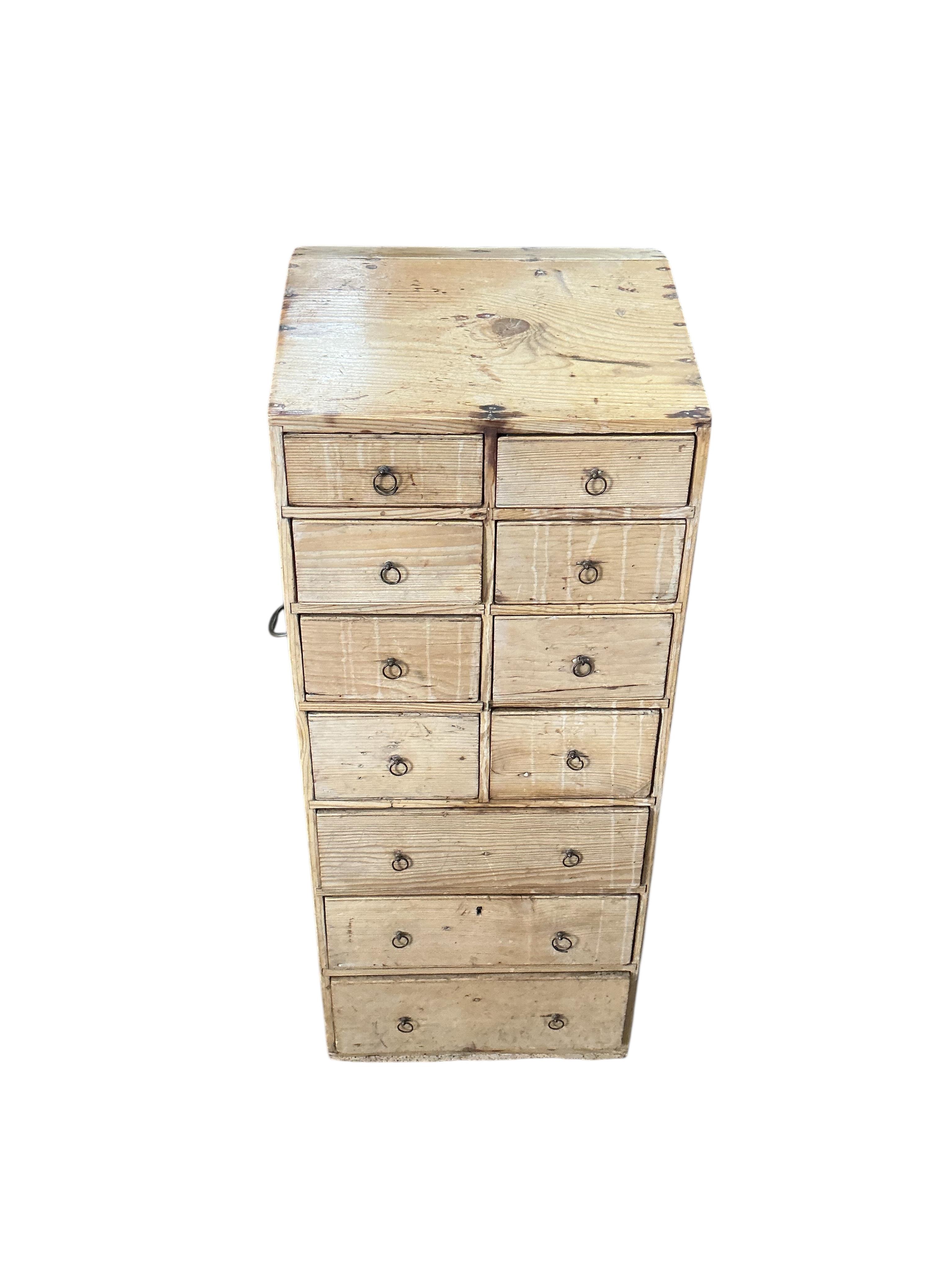 An early 19th century pine eleven drawer campaign chest with slant top, width 33cm, depth 26cm, height 80cm